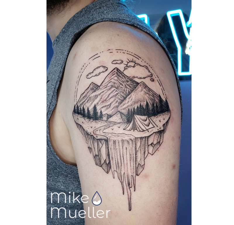 A person's arm with a small tattoo of mountains and a waterfall photo –  Free Havasu Image on Unsplash